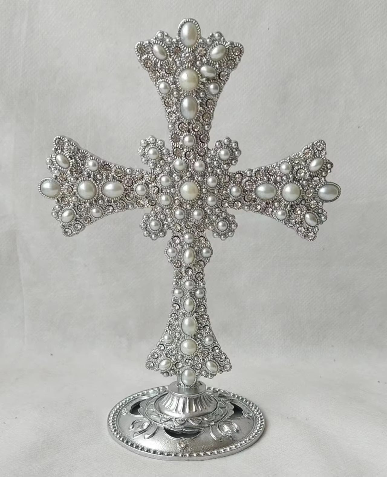 Tall stand  Pearl and stone encrusted cross .